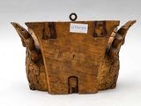 a wooden basket that has a tag on it