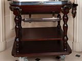 a small wooden table with a metal tray on it