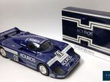 an image of a model of a blue race car next to a boxed box