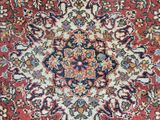 a red rug with a medallion design on it