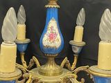 a blue and gold chandelier with five candles