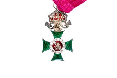 a pink ribbon with a cross and a crown on it