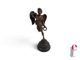 statue of an angel holding a trumpet on a white background