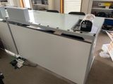 a desk that has a microwave on top of it