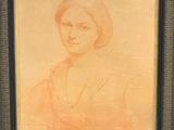 painting of a woman in an orange dress in a black frame