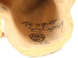 a close up of a vase with writing on it