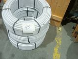 a coil of white wires on the floor in a room