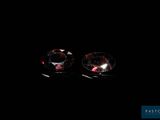 a pair of red diamond earrings on a black background