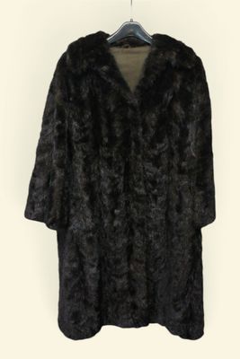 black fur coat on hanger against white background