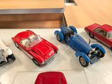 several toy cars are lined up on a table next to each other