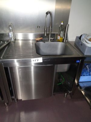 a stainless steel sink in a kitchen with a stainless steel counter top