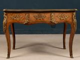 an old wooden table with two drawers and a marble top