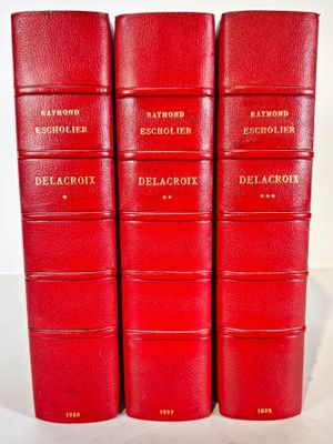four red books sitting on top of each other on a table