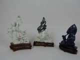 three figurines of a woman and a man on a horse