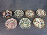 six chinese plates with different designs on them sitting on a table