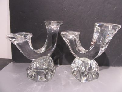 deux bougeoirs en verre transparent posés sur une table