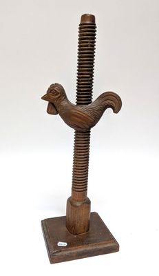 an image of a wooden sculpture of a bird on top of a wooden base