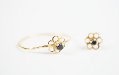 a pair of gold rings with black stones on them