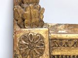 a picture of a mirror with a gold frame on the wall