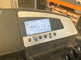 a close up of a tread machine with a screen on it