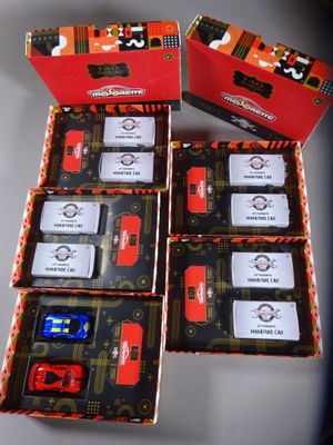 four boxes of red and black cars are sitting on a table