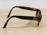 christian dior sunglasses on a wooden table