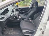 the interior of a car with the door open and the driver ' s seat down
