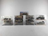five different models of military vehicles displayed in a display case