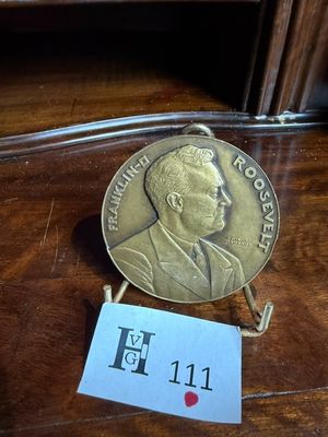 une pièce d'or sur laquelle figure l'image d'un homme