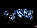 some very pretty blue diamonds on a black surface