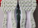 the soles of a pair of white shoes are on a box