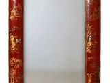 une image représentant un miroir au cadre rouge orné d'un motif d'animaux