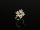 an 18k gold and diamond flower ring