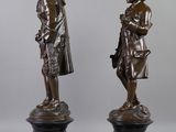 pair of bronze figures of a man and a woman on marble bases