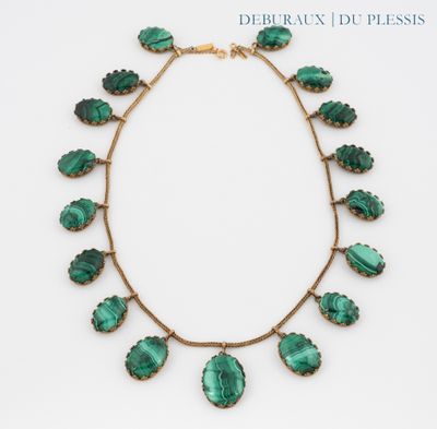 a close up of a green necklace on a white background