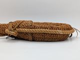 rope wrapped around a basket with a handle on a white background