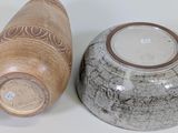 two vases sitting next to each other on a table