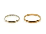 two gold and silver wedding rings on a white background