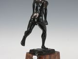 an image of a bronze statue of a man on a marble base
