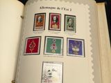 an open book with stamps on it on a table