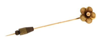 a wooden stick with a flower on top of it