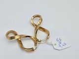 two pairs of gold colored scissors sitting on top of a white surface
