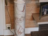 a lamp that is sitting on a pedestal in a room