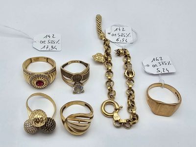 many different rings and bracelets on display on the table