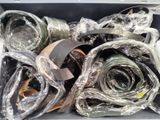 many rolls of fabric wrapped in plastic in a box