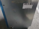 a metal box with a label on it sitting on the floor