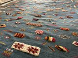 a blue rug with a lot of different designs on it