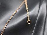 a close up of a gold necklace on a mannequin mannequin mannequin mannequin mannequin mannequin mannequin manne