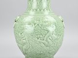 green vase with dragon handles on a white background