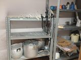 shelves with pots and pans on them in a small room